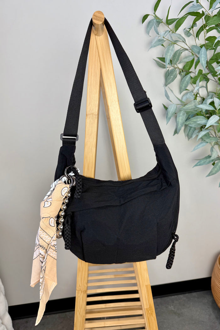 shoulder bag in two colors with multiple zippers