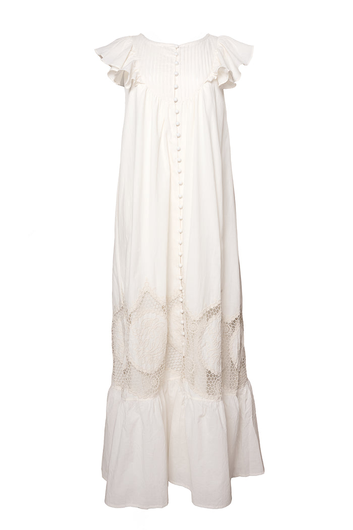 The Abigail Maxi Dress in Antique Ivory by Ivy City Co is a sleeveless, ankle-length dress featuring ruffled shoulders, decorative buttons down the front, and delicate lace detailing near the hem.