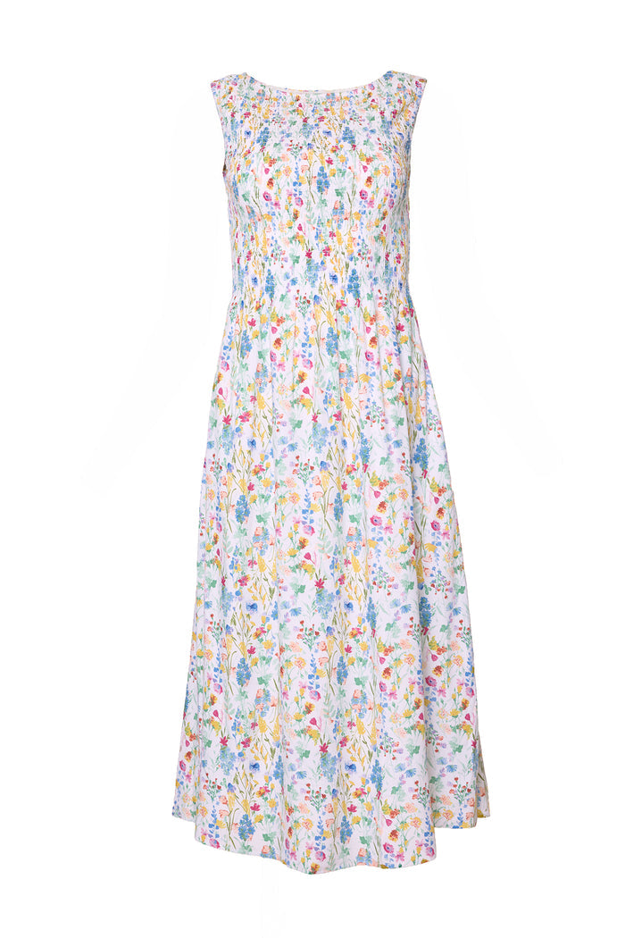 The Ana Dress in Floral Fields by Ivy City Co is a sleeveless, ankle-length floral print dress with a round neckline, colorful blooms on white, a smocked bodice for comfort, and maternity-friendly design.