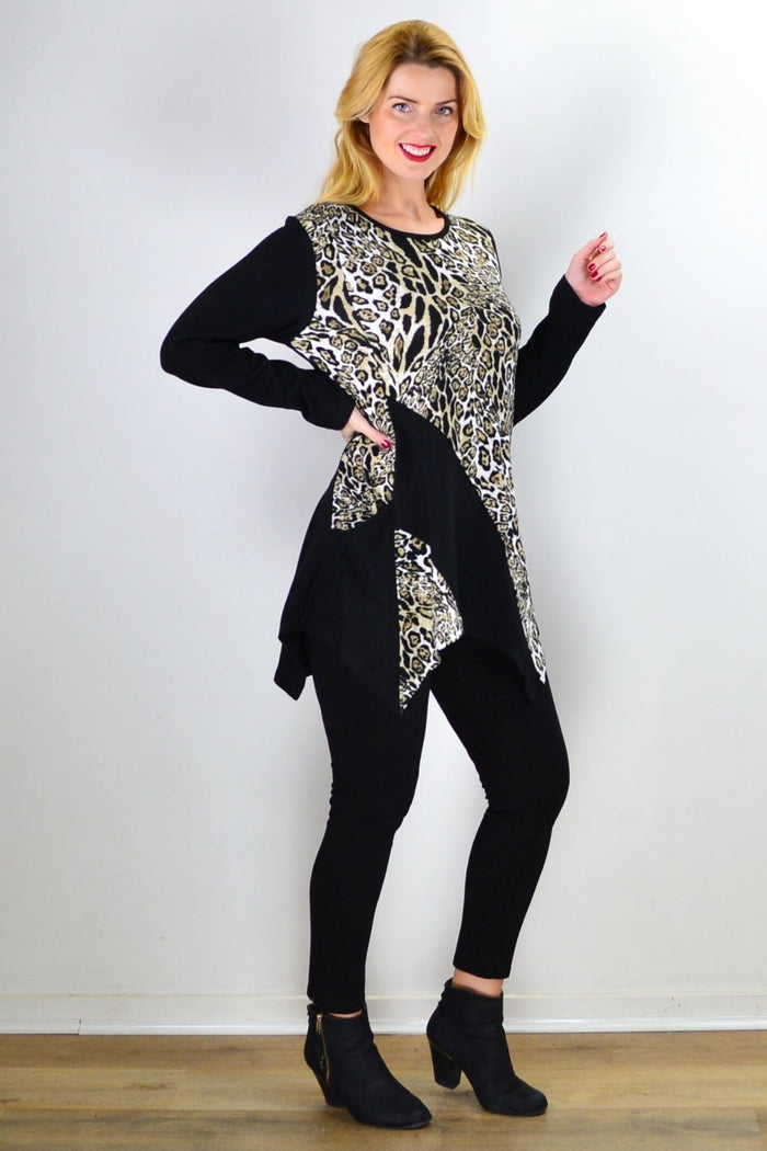 Animal print asymmetrical hem tunic top by Caroline Morgan displayed on a hanger, showcasing its stylish pattern and unique hem design.