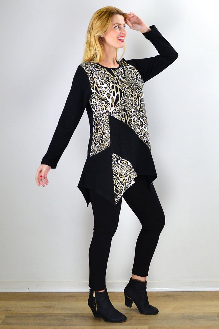 Caroline Morgan animal print asymmetrical hem tunic top displayed on a hanger with flowing fabric and bold animal pattern.