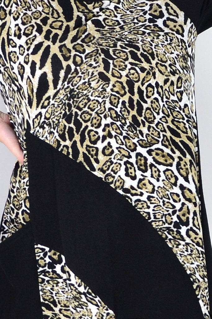 Caroline Morgan animal print asymmetrical hem tunic top with flowing fabric and bold pattern, displayed on a hanger.