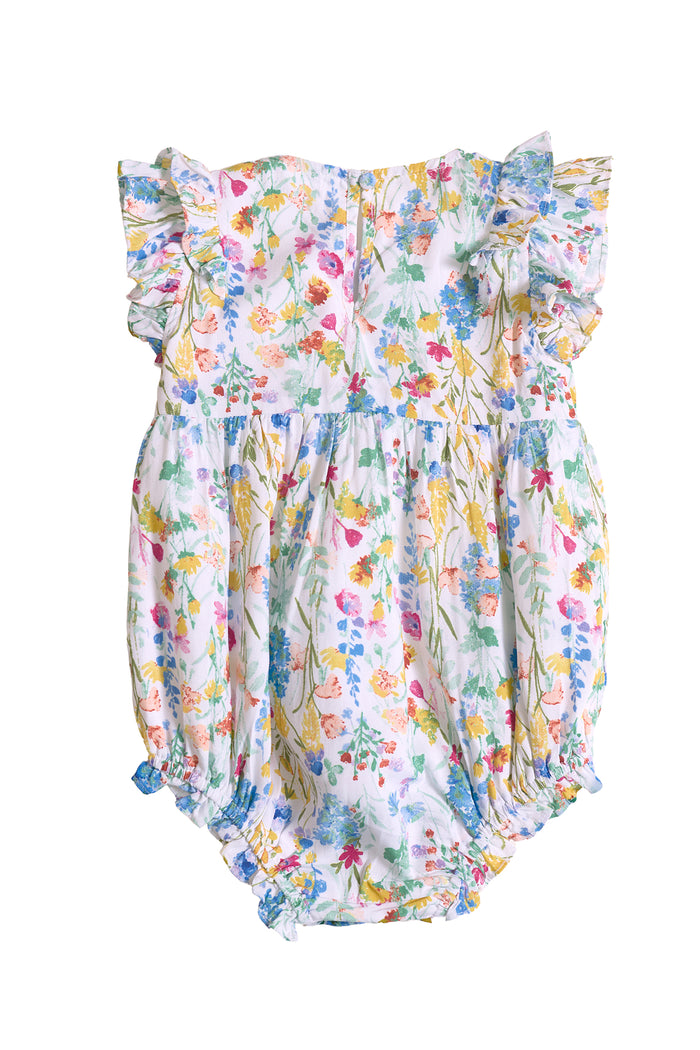 The Baby Ana Romper in Floral Fields by Ivy City Co features flutter sleeves, a colorful floral print on white, elastic leg openings, and a gathered waist for comfort—perfect for summer.