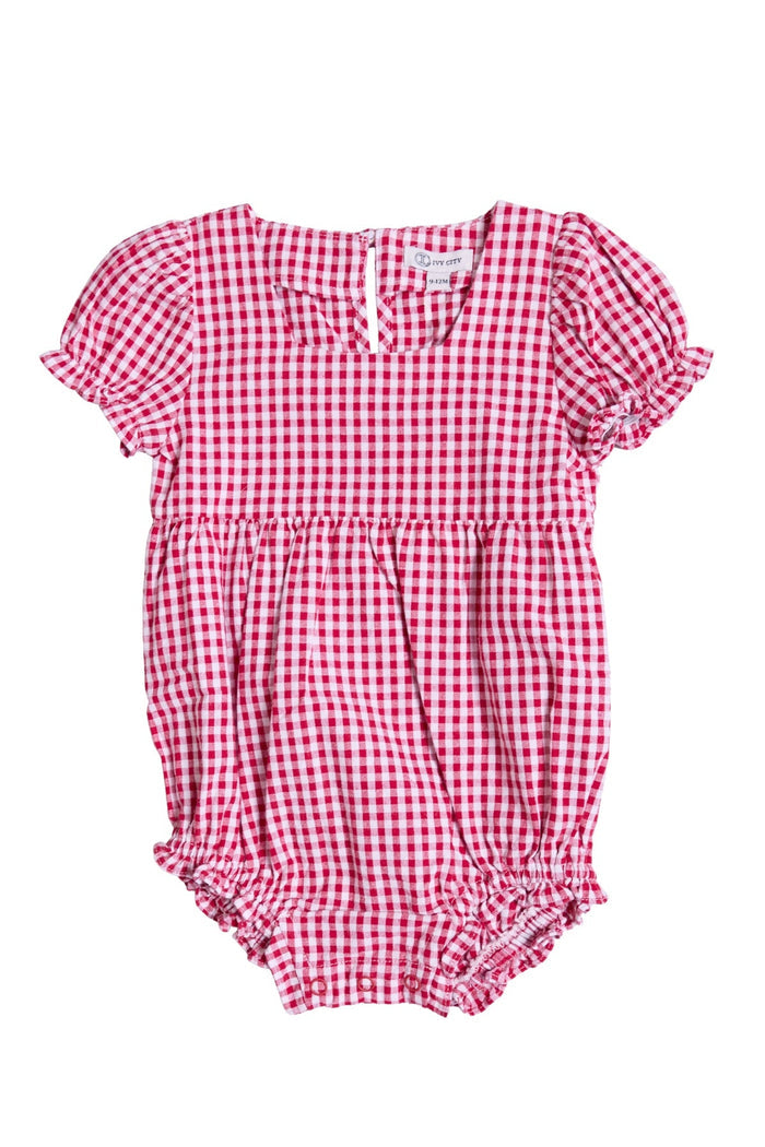 The Ivy City Co Baby Jessie Romper in Red Gingham features short puff sleeves, ruffled leg openings, and a buttoned back—making it a perfect festive choice for the Fourth of July or a charming everyday favorite.