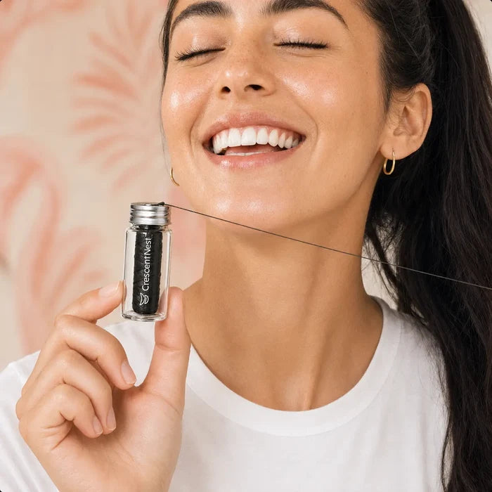 Woman holding Crescent Nest dental floss in a reusable glass jar