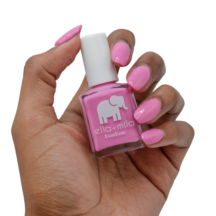 Beet Goes On bubblegum pink nail polish on a medium skin tone, hand holding the bottle
