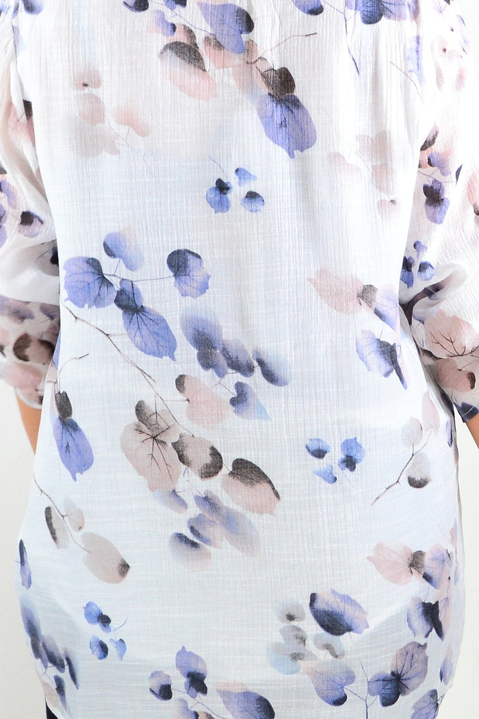 Blue floral botanical tunic top by Caroline Morgan, featuring a flowy fabric and vibrant floral pattern on a relaxed fit.