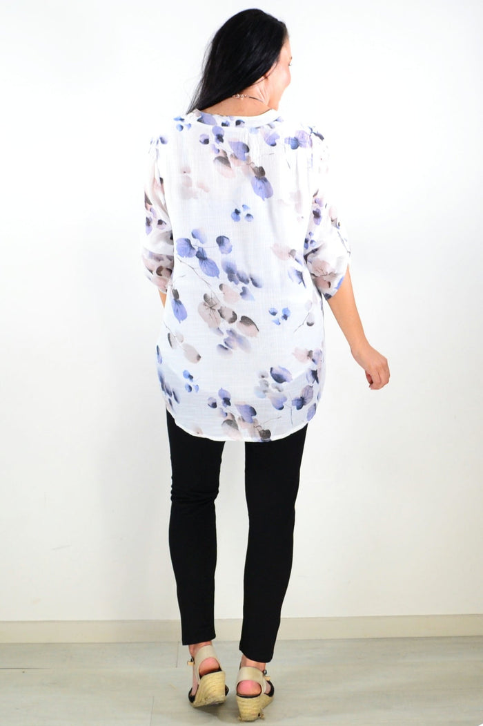 Blue floral botanical tunic top by Caroline Morgan, featuring lightweight fabric and a relaxed fit, displayed on a mannequin.
