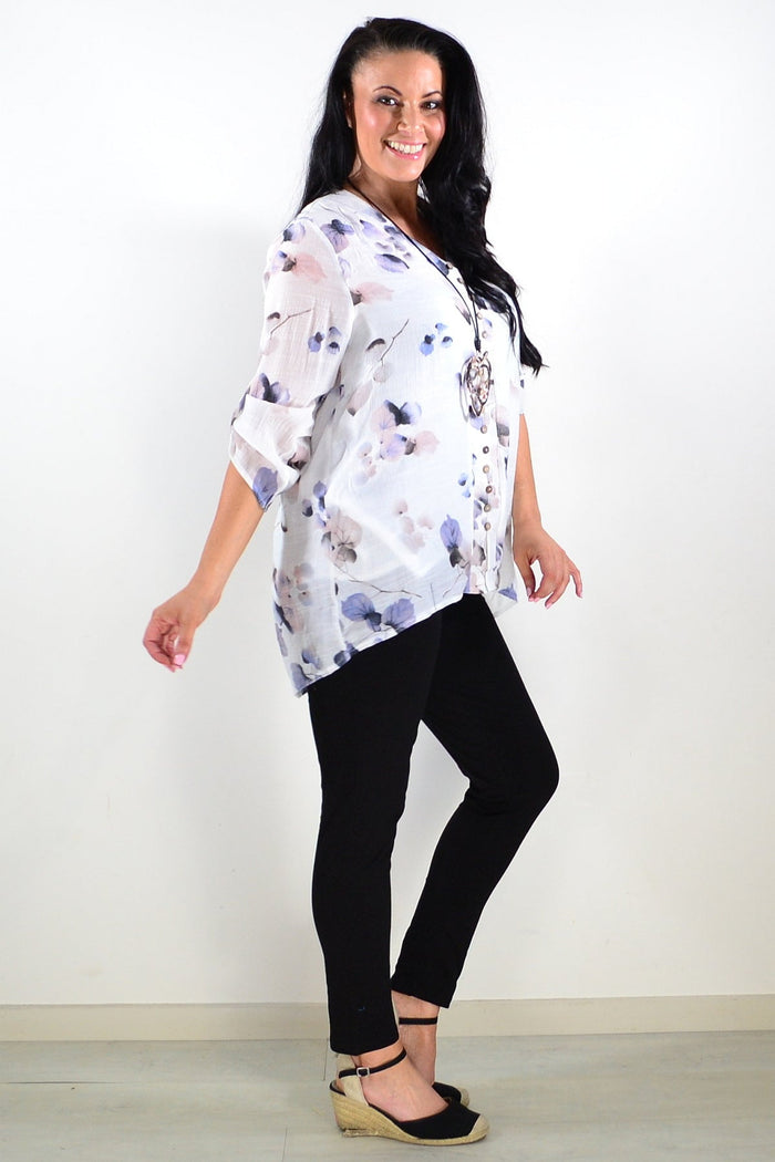 Blue floral botanical tunic top by Caroline Morgan, featuring a flowy design with vibrant flower patterns and long sleeves.