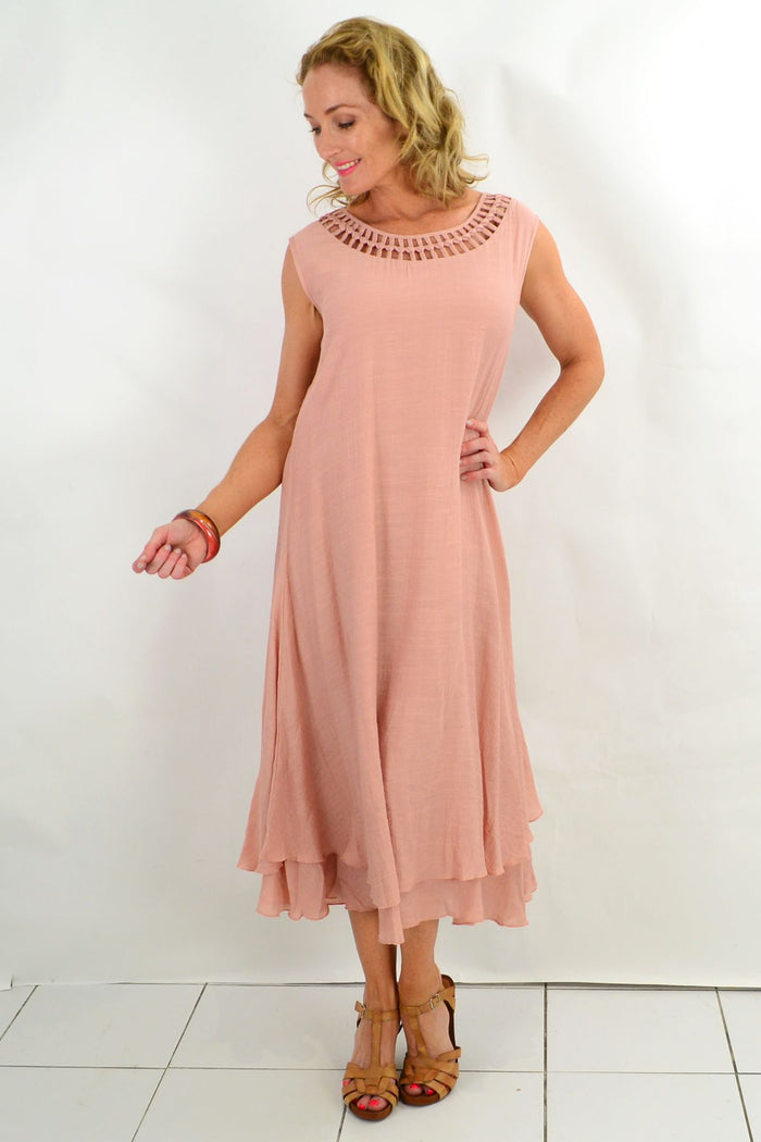 Light pink Grecian sleeveless tunic dress from La Mode, flowing fabric with draped design and elegant neckline.