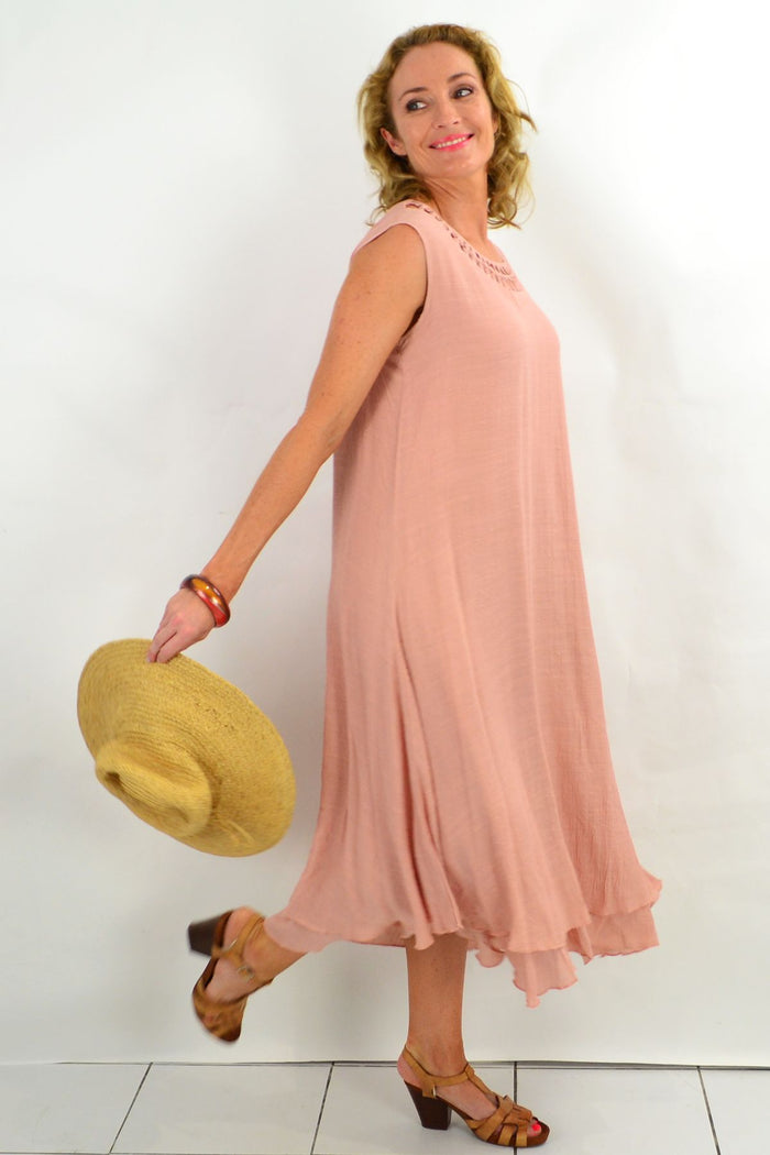 Grecian sleeveless blush tunic dress by La Mode, flowing fabric with elegant drape and subtle detailing, displayed on a hanger