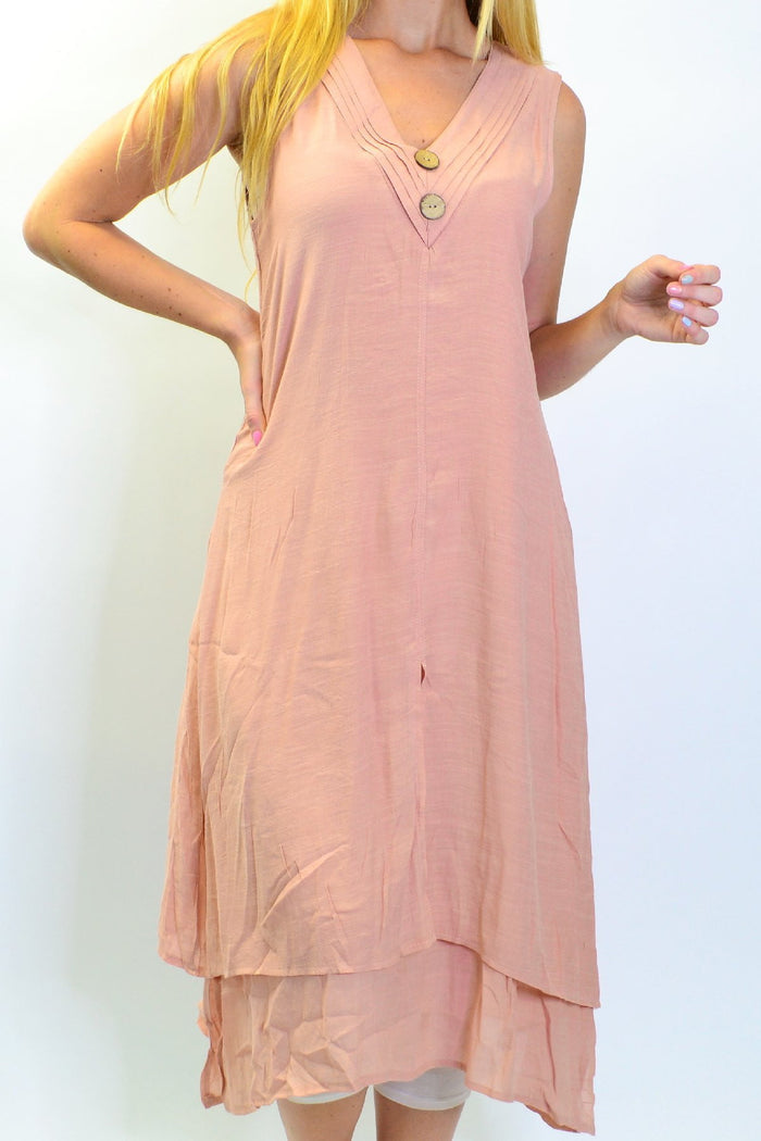 Blush pink sleeveless tunic dress with coconut button details by La Mode, shown on a hanger.