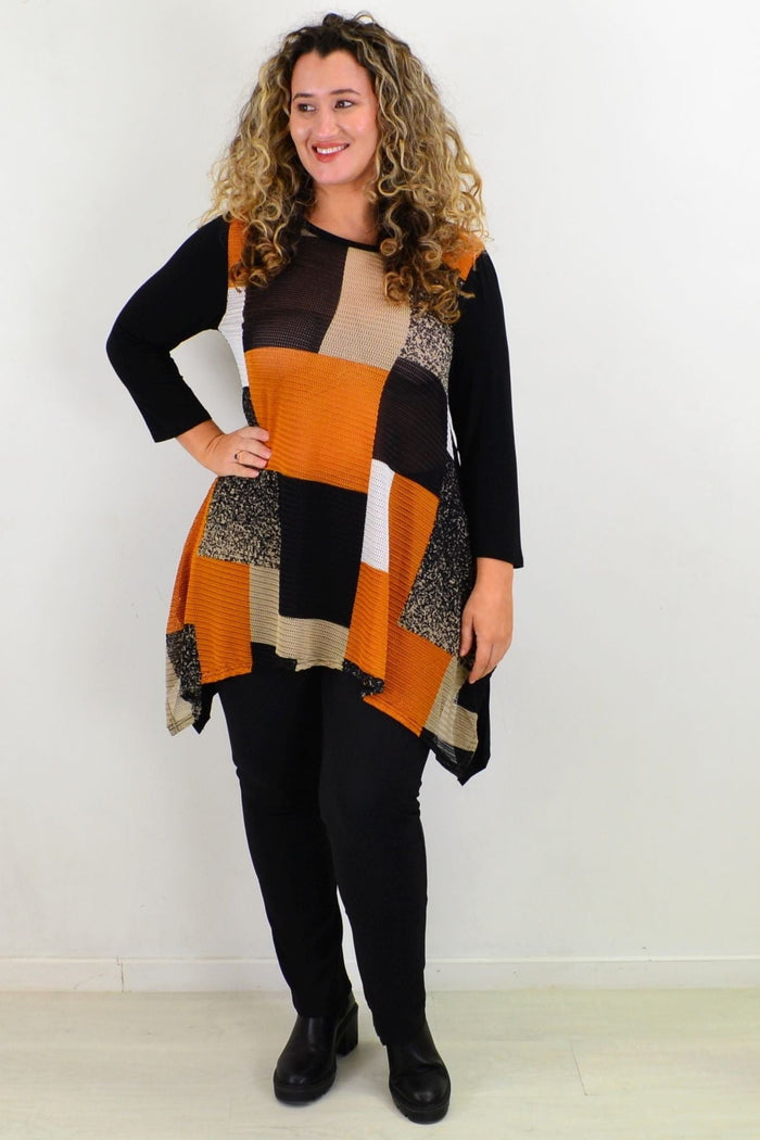 Caramel Caroline Morgan swing tunic top with flowing fabric and long sleeves, displayed on a hanger against a neutral background.