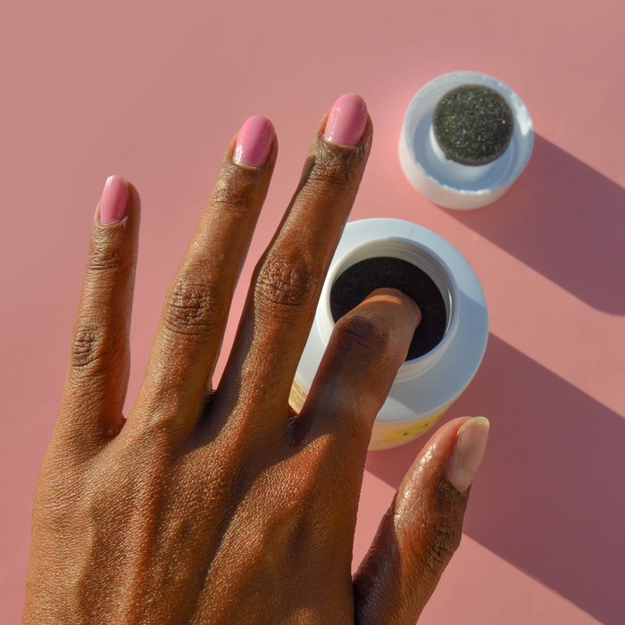 Dipping a finger into the Clean Break nail polish remover pot to remove pink polish
