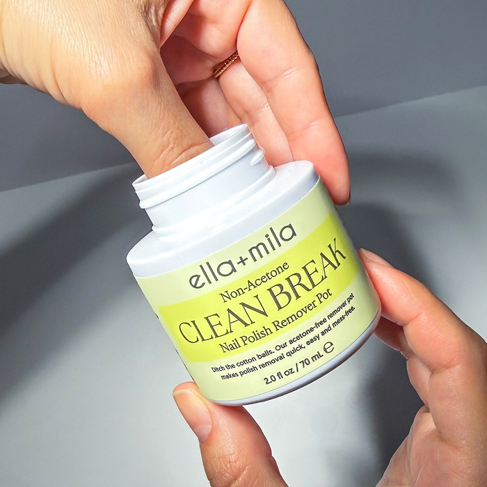 Hand holding the Clean Break non-acetone remover pot with the lid off