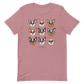 The Corgi Tee by Sassy Woof is a mauve unisex t-shirt with nine illustrated corgi faces in various fur colors and sunglasses above the Sassy Woof logo. Made from 100% cotton for lasting comfort.