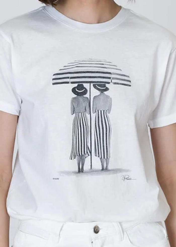 Woman wearing a black and white graphic tee with white jeans