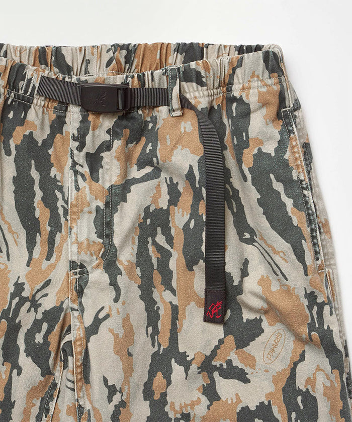 Close-up view of bark camo Denim Gramicci Pant Straight Fit on a light-tone background.