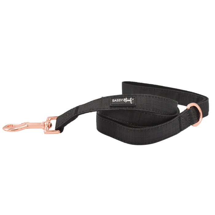 The Sassy Woof "Baby Got Black" dog leash features rose gold hardware and a branded label. Pair this elegant, black leash with a matching collar for a stylish walk.