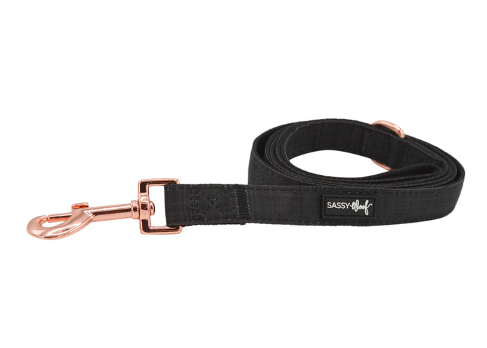 The Sassy Woof Dog Leash - Baby Got Black with a gold buckle pairs perfectly with a matching black collar or adjustable harness for a coordinated look.