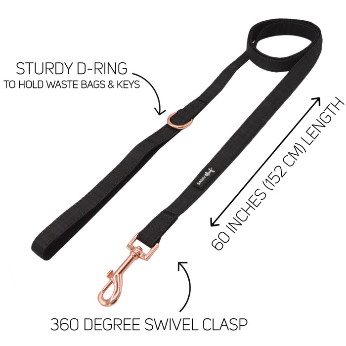 The Sassy Woof Dog Leash - Baby Got Black features a sturdy D-ring for bags/keys, measures 60 inches (152 cm), and has a rose gold 360° swivel clasp. Perfect match for an adjustable harness or black collar; arrows highlight each feature.