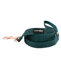 The Sassy Woof Dog Leash - Forest features a teal color, rose gold hardware, a handle, and a black-and-white Sassy Woof label. It is neatly coiled on a white background.