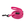 The Sassy Woof Dog Leash - Neon Pink features bright pink neoprene, a black metal clasp, handle loop, and black Sassy Woof label—coiled neatly on a white background, it’s a bold pick for neon dog accessory lovers.