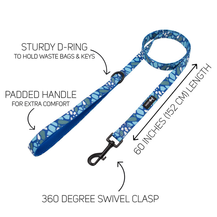 The Sassy Woof Dog Leash - Santorini features a blue pattern, soft neoprene handle, sturdy D-ring for bags or keys, 60-inch length (152 cm), and a 360° swivel clasp. Text labels highlight its features; pairs perfectly with the matching harness.