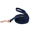 The Sassy Woof Dog Leash - Twilight is a coiled navy blue leash with rose gold hardware, a handle loop, and a black and white SASSY Woof tag.