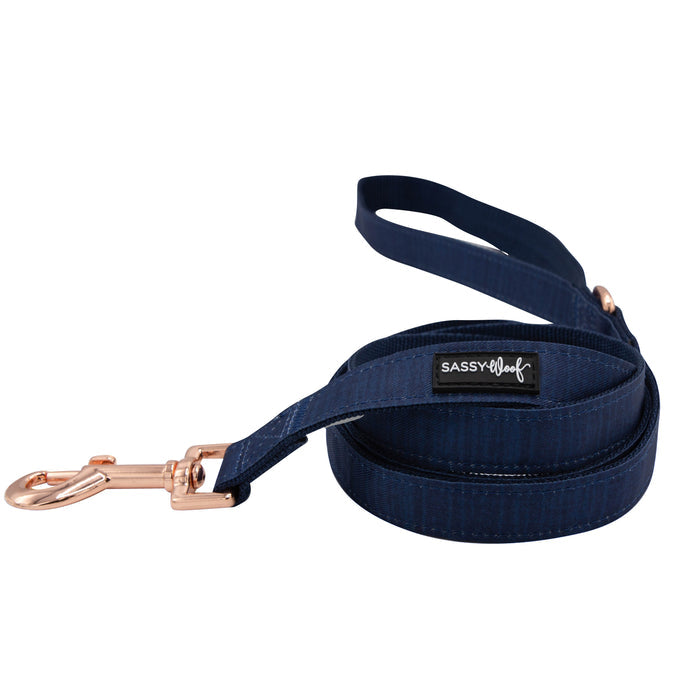 The Sassy Woof Dog Leash - Twilight is a coiled navy blue leash with rose gold hardware, a handle loop, and a black and white SASSY Woof tag.