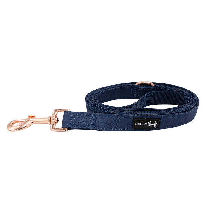 The Sassy Woof Dog Leash - Twilight features navy blue material, rose gold hardware, and a Sassy Woof label on the handle.