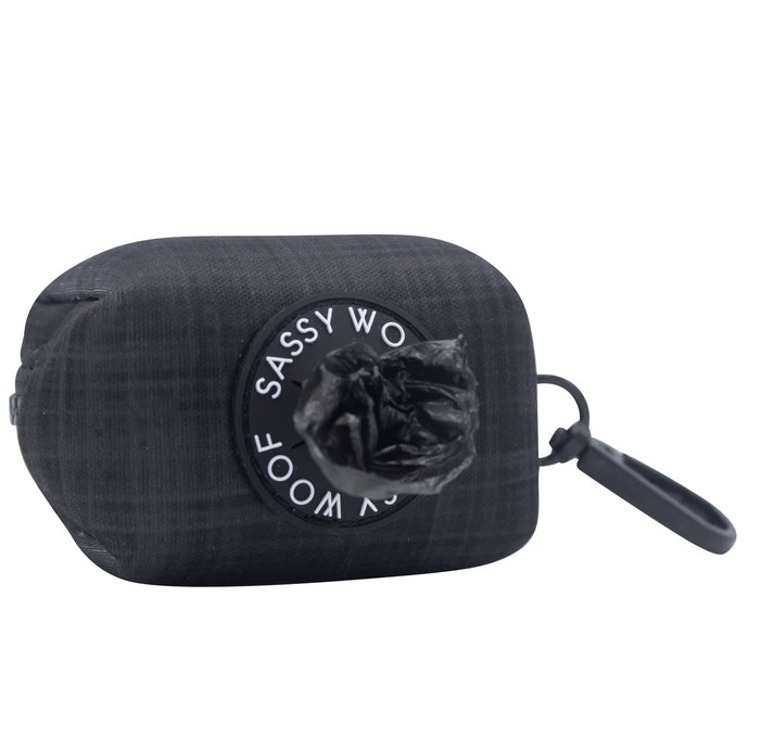 The Sassy Woof Dog Waste Bag Holder - Baby Got Black is a stylish holder with a plastic bag, perfect as a daily dog walking accessory.