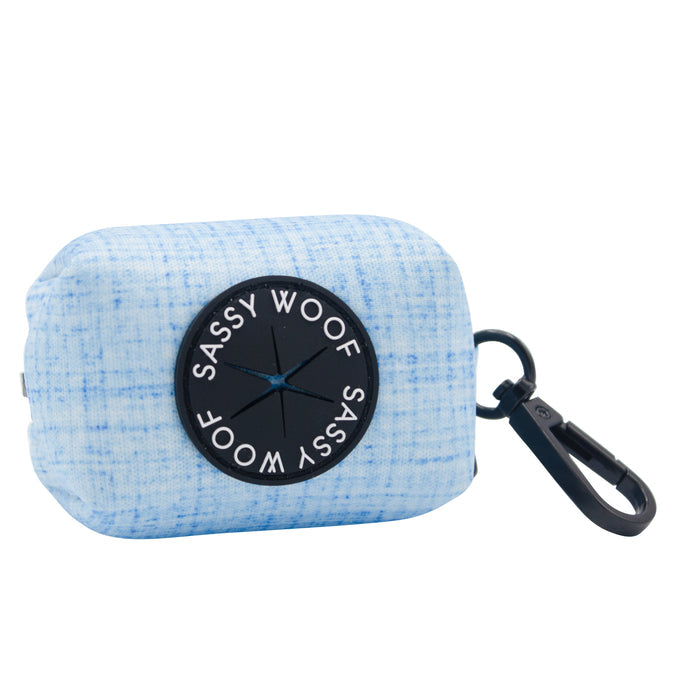 The Dog Waste Bag Holder - Blumond by Sassy Woof is a light blue textured neoprene accessory with a black SASSY WOOF label and clip, making it the perfect waste bag holder for walks.