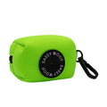The Sassy Woof Dog Waste Bag Holder - Neon Green is a bright green rectangular neoprene holder with a black circular label and clip, ideal for carrying dog waste bags and pairing with matching neon accessories or harnesses.