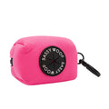 The Sassy Woof Dog Waste Bag Holder - Neon Pink features a black patch and a sturdy clip, perfect for carrying small items. Pair it with matching accessories for vibrant dog walks.