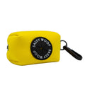 The Sassy Woof Dog Waste Bag Holder in Neon Yellow is a rectangular neoprene pouch with a black clip and circular logo, designed to match your dog's harness or neon accessories for easy attachment to a leash or bag.
