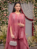 Woman in a pink traditional outfit with floral decorations in the background