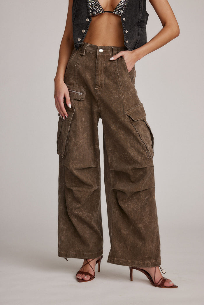 Fleetwood washed brown wide-leg cargo pants styled with denim vest and strappy heels.
