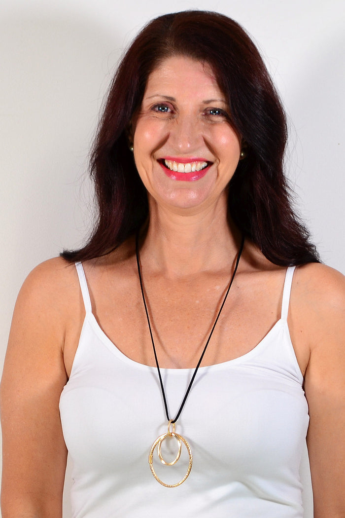 Golden oval rings pendant necklace with a silver chain, featuring multiple interconnected oval rings, by I Love Tunics.