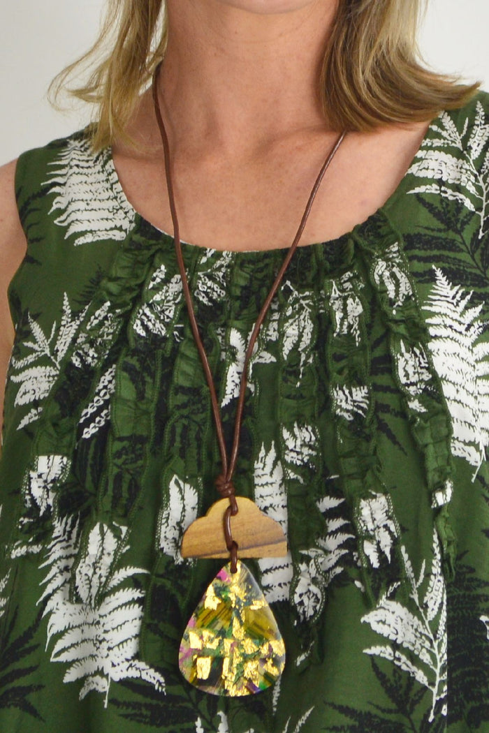 Green frilly Fern Tunic Dress by Willow Tree, featuring ruffled details and a flowy silhouette, displayed on a hanger.