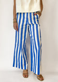 Person wearing blue and white striped pants on a plain background