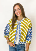 Woman wearing blue and mustard patterned cardigan