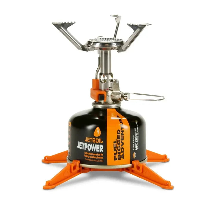 Jetboil MightyMo Camping Gas Stove set-up with gas canister and base support on a white background