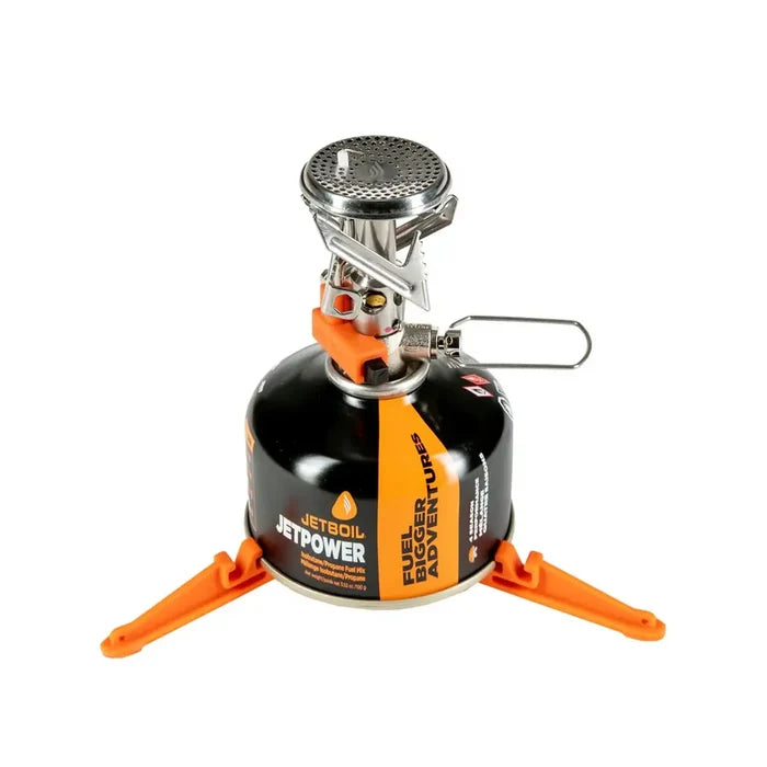 Jetboil MightyMo Camping Gas Stove set-up with gas canister and base support with the pot supports folded down on a white background