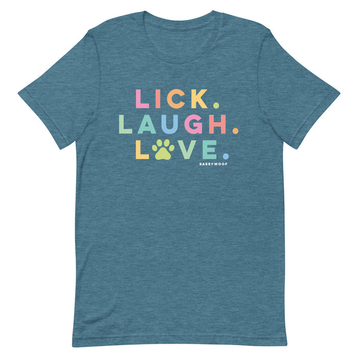 The Sassy Woof Lick, Laugh, Love Tee is a blue lightweight summer shirt with colorful text and dots. LOVE features a paw-print O, and Sassy Woof is printed below—making it a fun unisex pet tee perfect for dog lovers!.