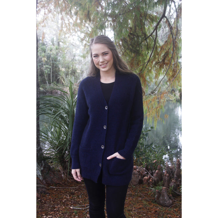 Woman standing. Wearing boyfriend cardigan in Midnight colour