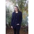 Woman standing. Wearing boyfriend cardigan in Midnight colour