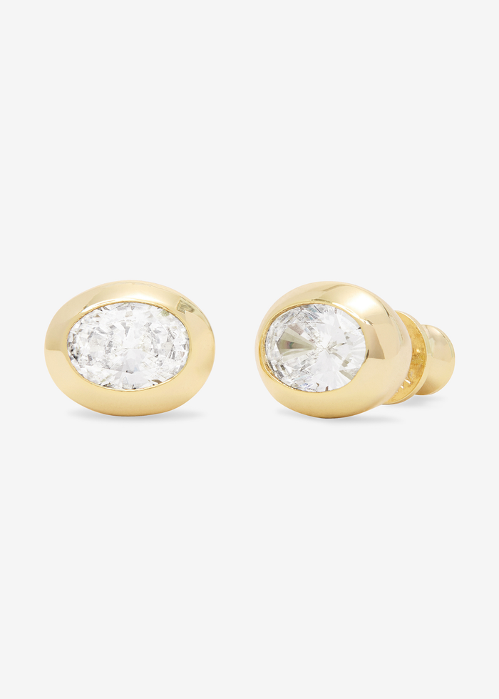 Gold framed oval shaped simulated diamond earrings on a white background