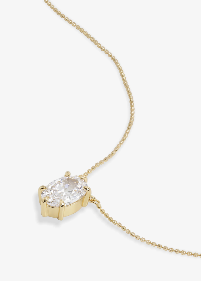 Gold simulated diamond pendant neckline on a white background