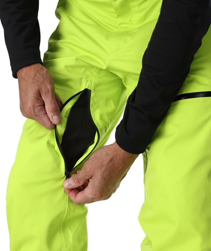 Person wearing bright yellow pants with a black zipper pocket on a white background